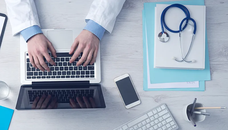 join-the-directory PRP Doctor making platelet rich plasma treatments notes on laptop